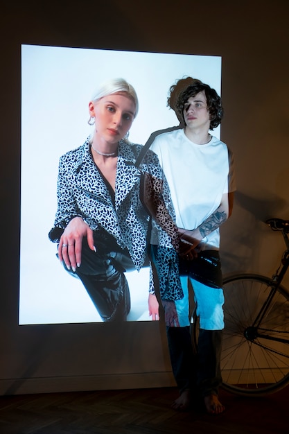 Photo couple taking photos in the light of movie projector