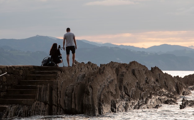 Couple taking pictures on the coast