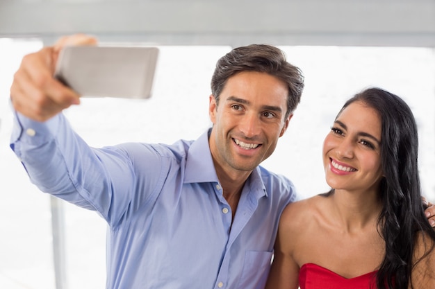 Couple taking a selfie in cafe