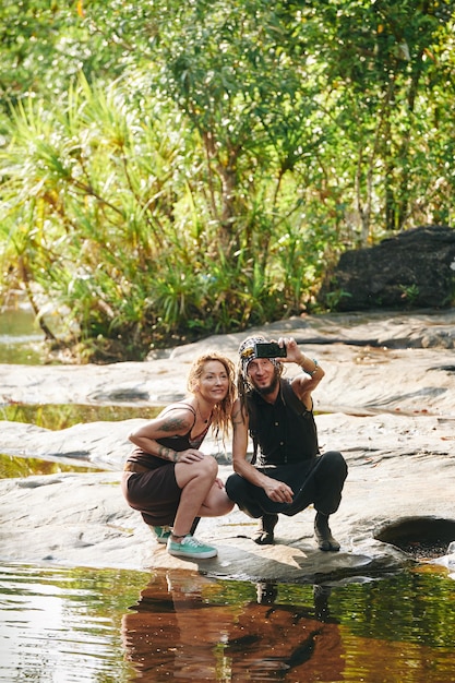 Couple taking selfie in forest