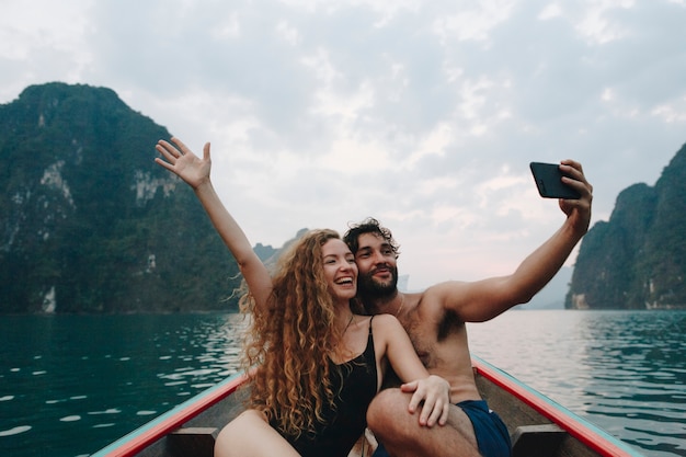 Couple taking selfie on a longtail boat