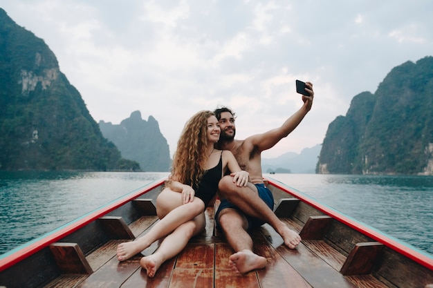 Couple taking selfie on a longtail boat