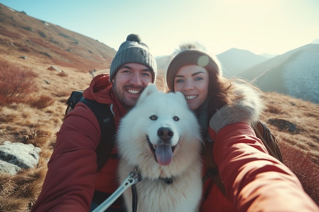 A couple taking a selfie with their pet samoyed dog in the mountains travel concept