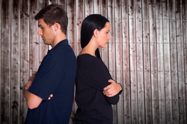 Couple not talking after argument against wooden planks