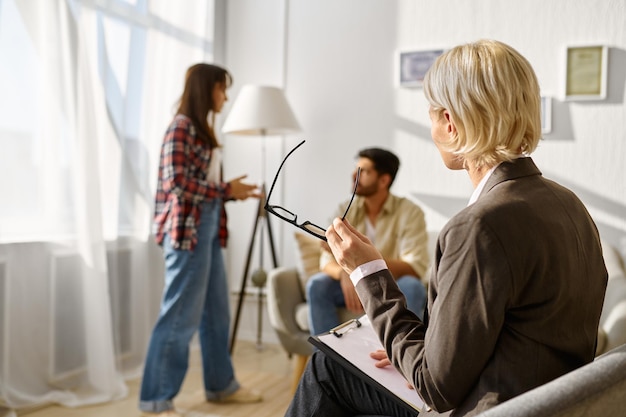 Couple not talking after argument at psychotherapy session.\
offended woman turned back to boyfriend