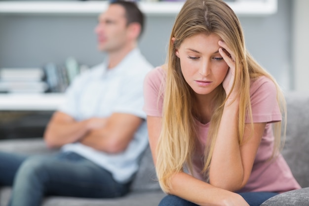 Couple not talking after a fight on the sofa