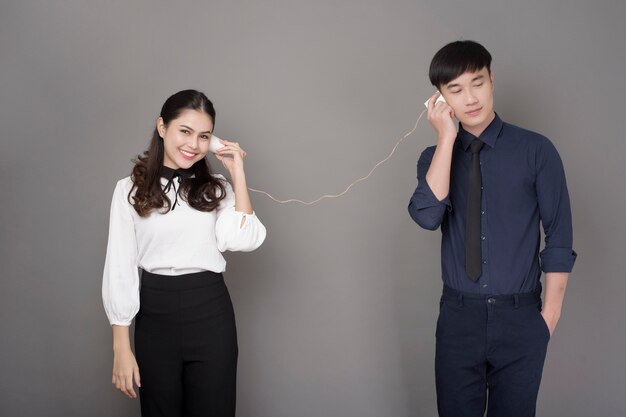 Couple talking through paper phone