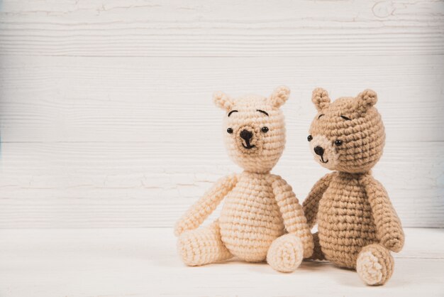 Couple teddy bear crochet knitting handmade on white wood