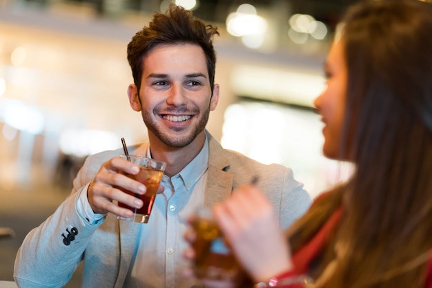 Couple toasting glasses in a disco