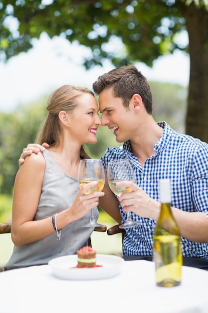 Couple toasting glasses of wine in a restaurant