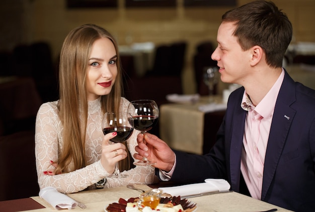 Couple toasting wineglasses in a luxury restaurant. 