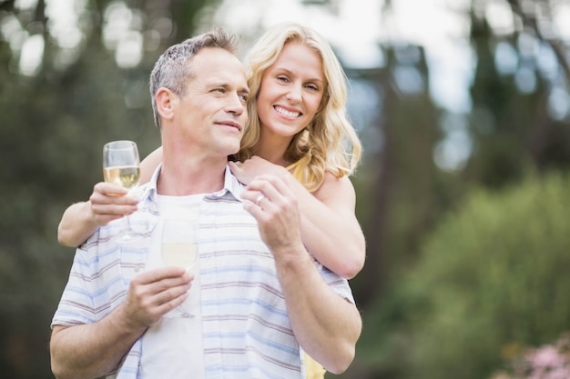 Couple toasting with champagne outside