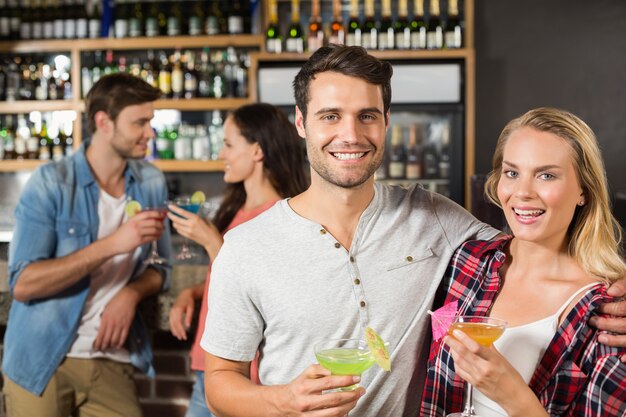 Couple toasts with cocktails