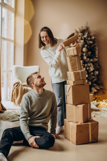 Couple together holding christmas presents