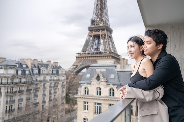 Couple tourists in front of the Eiffel tower Paris