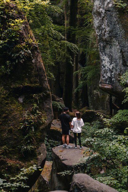 Couple tourists hiking at canyon in the forest