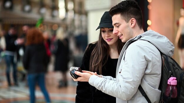 Couple of tourists looking at the pictures shot in their trip