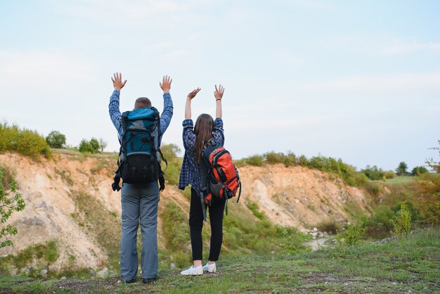 A couple of tourists in time of trip steel and admire the beautiful mountain scenery