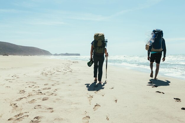 couple tourists walking on the beach