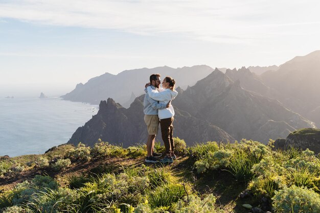 Couple of traveler enjoying vacation in nature Hikers watching beautiful coastal scenery