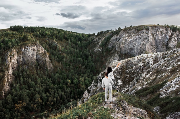 Couple traveling through the mountains. Couple in love in the mountains. Man and woman traveling. A walk in the mountains