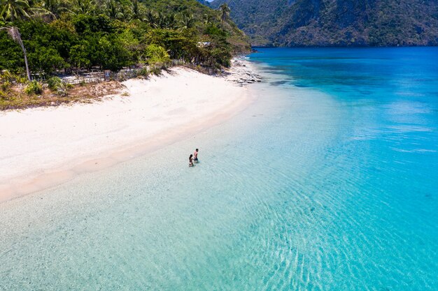 Couple on a tropical beach in El Nido, Palawan, Philippines