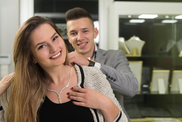 Couple Trying Necklace at Jewelry Store