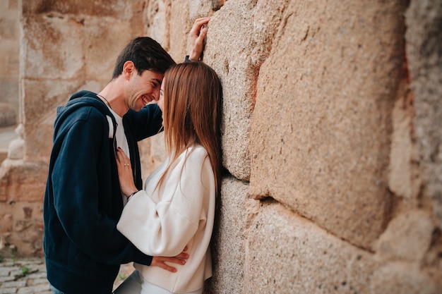 Couple of two people, a Caucasian boy and a girl. The two about to kiss while looking at each other.