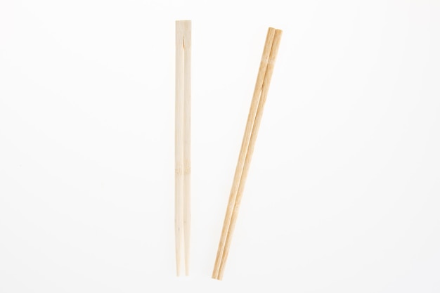 Couple two wooden chopsticks isolated on white background