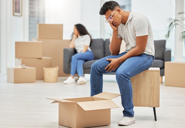couple unhappy and man worry with box for moving stress lost items and overwhelmed with change of home woman sofa and upset with partner for furniture placement disagreement and miscommunication