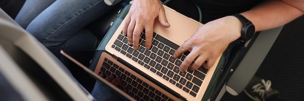 Couple using gadgets on airplane