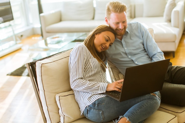 Couple using laptop in the room