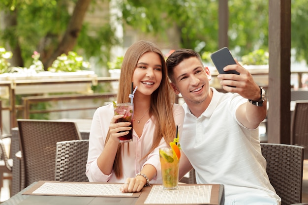 Couple using mobile phone in cafe