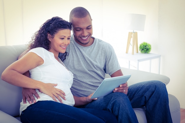 Couple using tablet computer