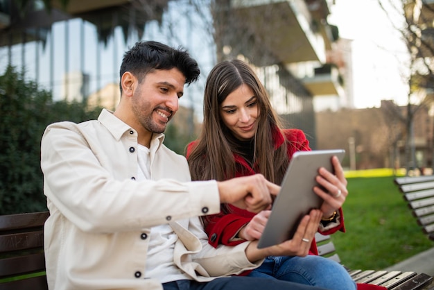 Couple using a tablet outdoors