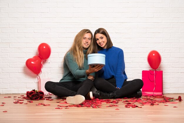 Photo couple in valentine day holding a gift in hands