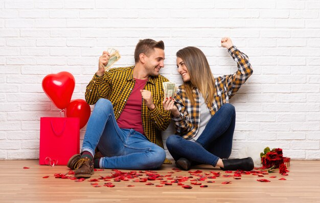 Couple in valentine day at indoors taking a lot of money