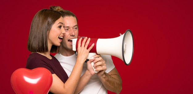 Couple in valentine day shouting through a megaphone