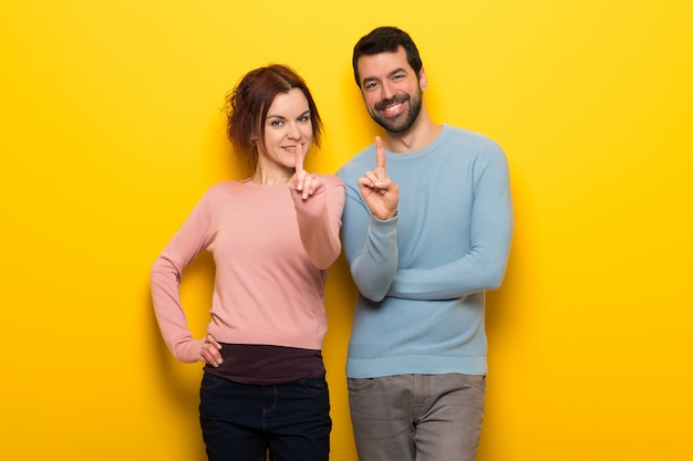 Couple in valentine day showing and lifting a finger