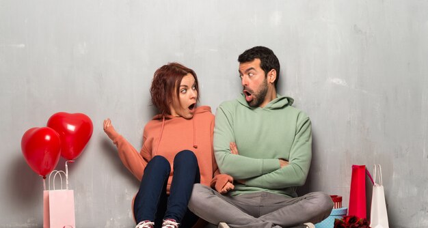 Couple in valentine day with surprise and shocked facial expression