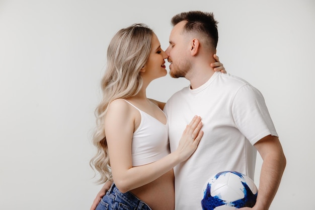 couple waiting for a baby Closeup of young caucasian couple kissing each other against white love