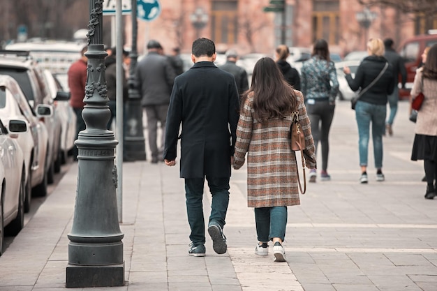 A couple walk along a city