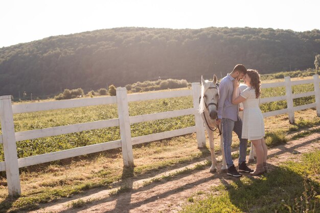 Couple walk at the ranch during summer day