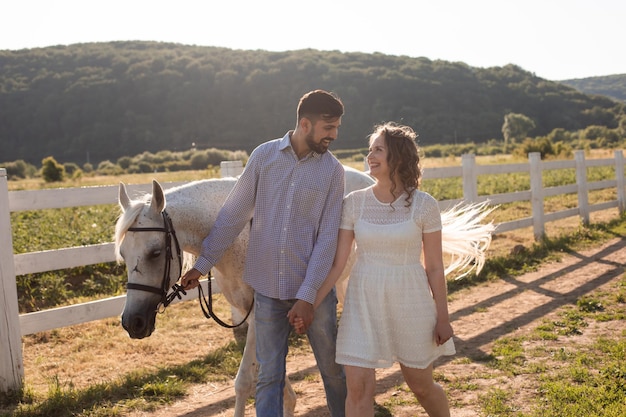 Couple walk at the ranch during summer day