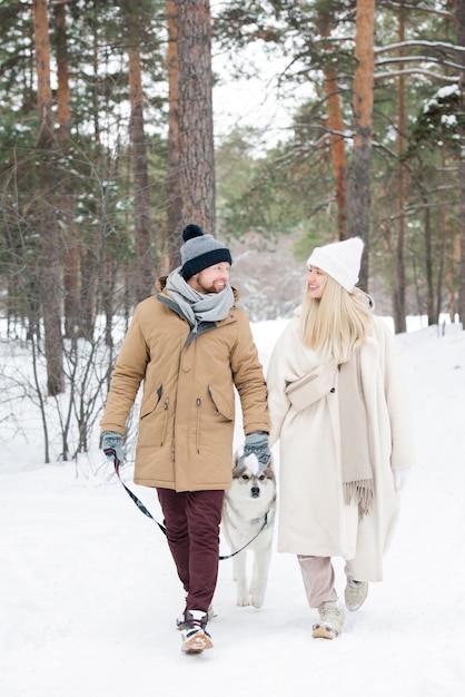 Couple Walking Dog On Winter Day