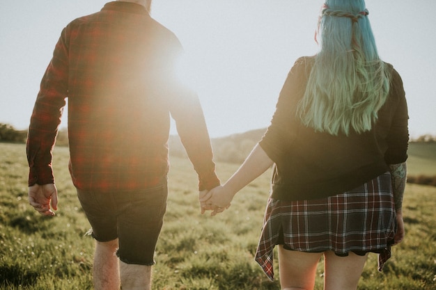 Couple walking and holding hands outdoors