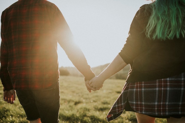 Couple walking and holding hands outdoors