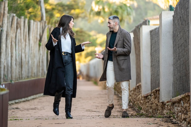 A couple walking on a path and arguing