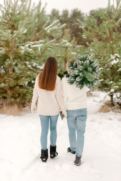 Couple walking in snowy forest