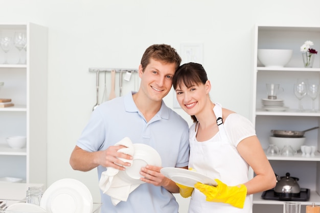 Couple washing dishes together